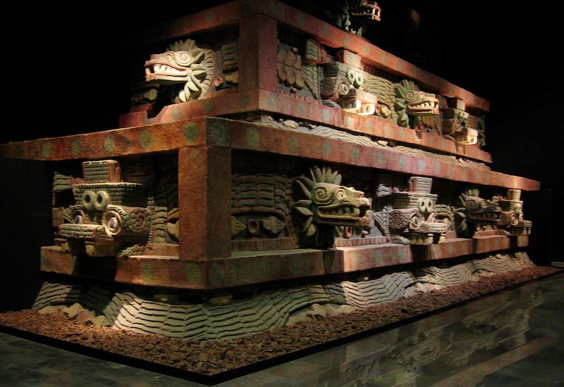 Teotihuacan style architecture displaying decorative ornamentation made of obsidian and shell inlaid into a painted cantera surface set upon a tezontle interior