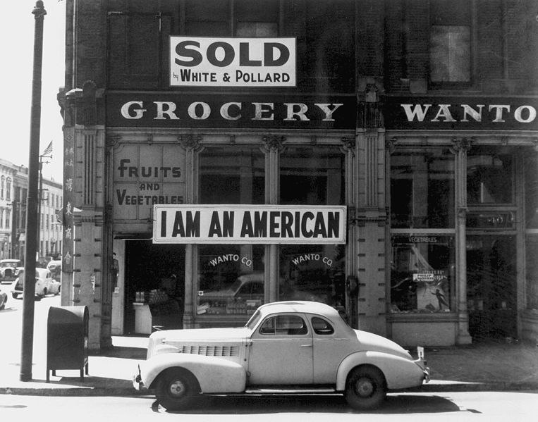 A Japanese American unfurled this banner the day after the Pearl Harbor attack. This Dorothea Lange photograph was taken in March 1942, just prior to the man's internment.