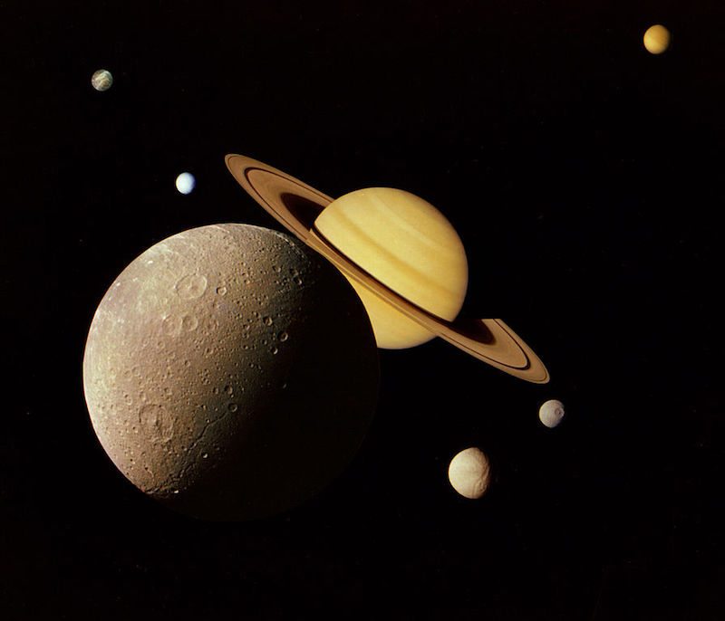 A montage of Saturn and its principal moons (Dione, Tethys, Mimas, Enceladus, Rhea and Titan; Iapetus not shown). This famous image was created from photographs taken in November 1980 by the Voyager 1 spacecraft
