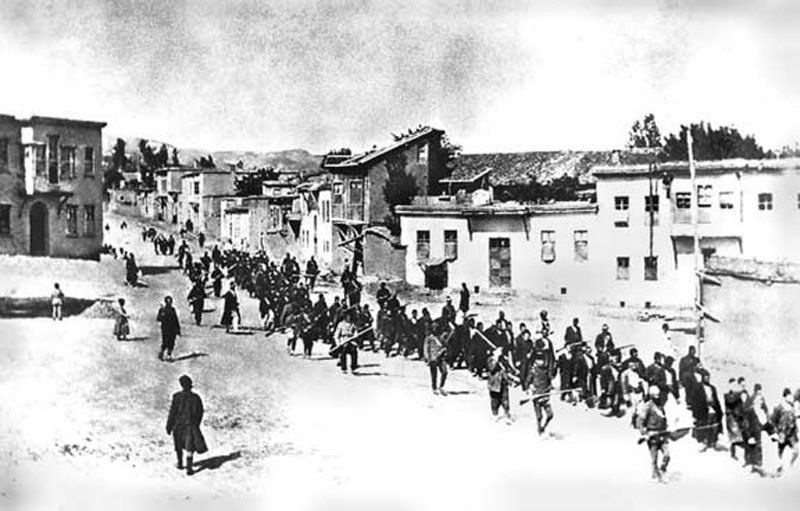 Armenian civilians, escorted by Ottoman soldiers, marched through Harput (Kharpert) to a prison in nearby Mezireh (present-day Elâzığ), April 1915.